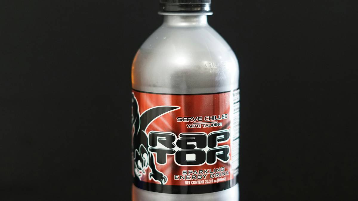 Gamer sipping customized gaming energy blends during late-night session